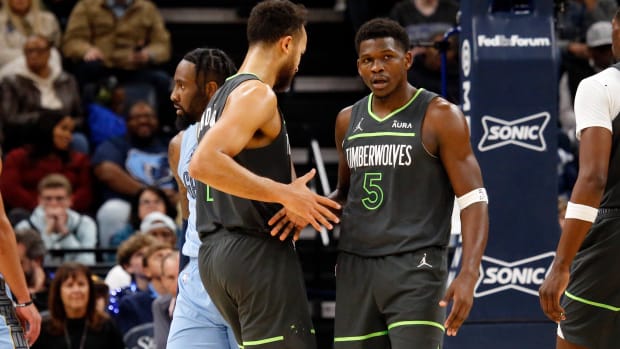 Nov 26, 2023; Memphis, Tennessee, USA; Minnesota Timberwolves guard Anthony Edwards (5) reacts with forward-guard Kyle Anderson (1) during the second half against the Memphis Grizzlies at FedExForum. 